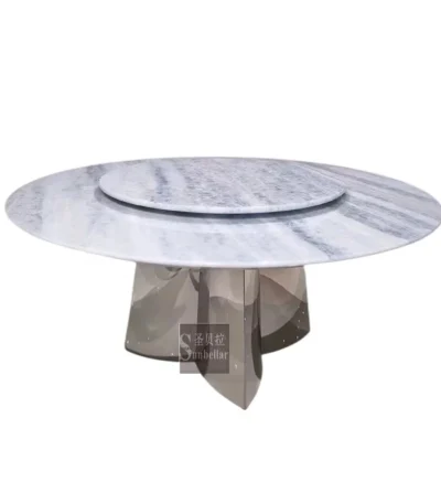Modern marble round dining table with sintered stone top and titanium gold stainless steel base in a stylish dining room setting.