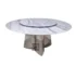 Modern round dining table with white marble top and gold stainless steel base in a bright dining room
