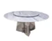 Modern round dining table with white marble top and gold stainless steel base in a bright dining room