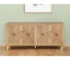 Natural wood sideboard with four carved geometric doors in a dining room setting
