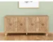 Natural wood sideboard with four carved geometric doors in a dining room setting