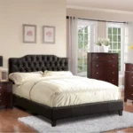 Modern faux leather queen bed with tufted upholstered headboard in a stylish bedroom setting