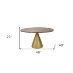 Round pedestal dining table with brown solid wood top and gold iron base, 48 inch, in a dining room setting