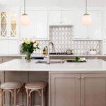 Wide shot of the brass kitchen pendant light, illuminating a dining table with chairs.