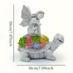 Close-up of the solar angel and turtle statue, showing textured resin finish and solar panel on the angel's back.