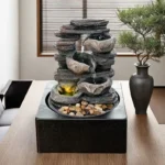 Goldoma fountain on a shelf among office decor, USB plugged into a laptop, compact size fitting small spaces,