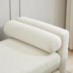 Goldoma upholstered bench daybed ottoman with wood legs and two bolster pillows in a modern living room setting
