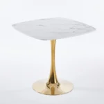 Modern square dining table with marble top and gold metal base in a small apartment dining room