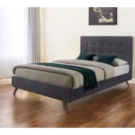 Goldoma button tufted king bed frame with gray upholstered headboard and brown wood base in a bedroom setting