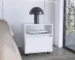 White nightstand with drawer, open shelf, and casters in a modern bedroom