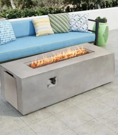 Rectangular MgO propane fire pit table with glowing flames on a patio