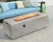 Rectangular MgO propane fire pit table with glowing flames on a patio