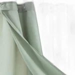 Modern grid sage green shower curtain with waterproof PEVA material in a bright bathroom