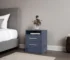 Blue nightstand with drawers in a modern bedroom setting