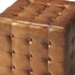 Goldoma brown tufted faux leather cube ottoman as footrest and extra seat in living room