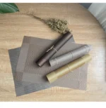 Gold weave placemats on a dining table with plates and cutlery