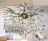 Modern crystal chandelier with black K9 crystal tree branches hanging in a dining room