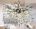 Modern crystal chandelier with black K9 crystal tree branches hanging in a dining room