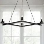 Close-up of the square black chandelier showing the metal frame and clear glass shades, hanging from a ceiling.