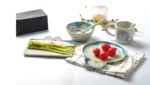 Japanese ceramic dinnerware set with hand-drawn cat design on blue rectangular plate and bowl