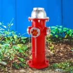 Close-up of solar-powered fire hydrant decor showing textured resin surface and glowing solar panel on top.