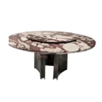 Modern round dining table with white marble top and gold stainless steel base in a bright dining room