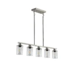 The 5-light chandelier illuminated, casting warm light through clear glass shades in a dining room.