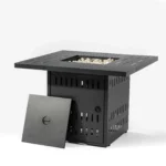 Modern outdoor gas fire pit column with blue flames on a stone patio