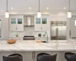 Close-up of the adjustable hanging ceiling light showing brushed nickel finish and clear glass globes.