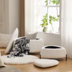 White faux fur storage ottoman set of 2 with metal legs placed in bedroom as footrest and shoe changing stool