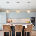 Close-up of the chrome spiral stripes and crystal chandelier pendant, showing reflective metallic finish.