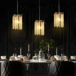 Golden mini crystal chandelier pendant light illuminating a kitchen island with modern luxury style.