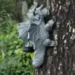 Solar dragon lantern glowing on a tree trunk at night, dragon figurine resin garden decor