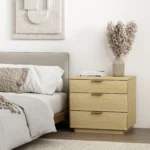 Natural oak nightstand with 3 drawers in a modern bedroom setting