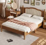 Modern teak finish full size bed with fabric upholstered headboard in a bedroom setting