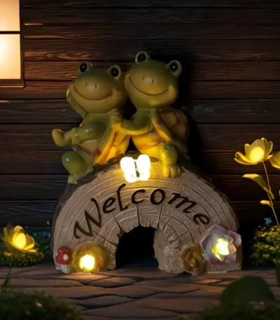 Solar turtle statue glowing in garden at night
