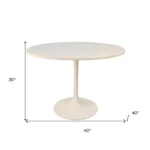 White marble round dining table 40 inch with iron pedestal base in a modern dining room setting