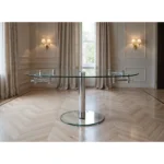 40 inch clear glass extendable dining table with self-storing leaf and silver metal pedestal base, modern design