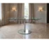 40 inch dining table with clear glass top and silver metal base, extended with self-storing leaf