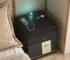 Modern bedroom with a bedside table with wireless charger and LED lights