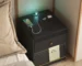 Modern bedroom with a bedside table with wireless charger and LED lights