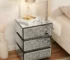 Crushed diamond nightstand with mirrored finish and three drawers in a bedroom setting
