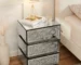 Crushed diamond nightstand with mirrored finish and three drawers in a bedroom setting
