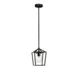 Black cage pendant light illuminating a wooden dining table in a cozy hotel lobby.