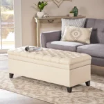 Purple fabric storage ottoman with hidden compartment and birch wood legs in a living room