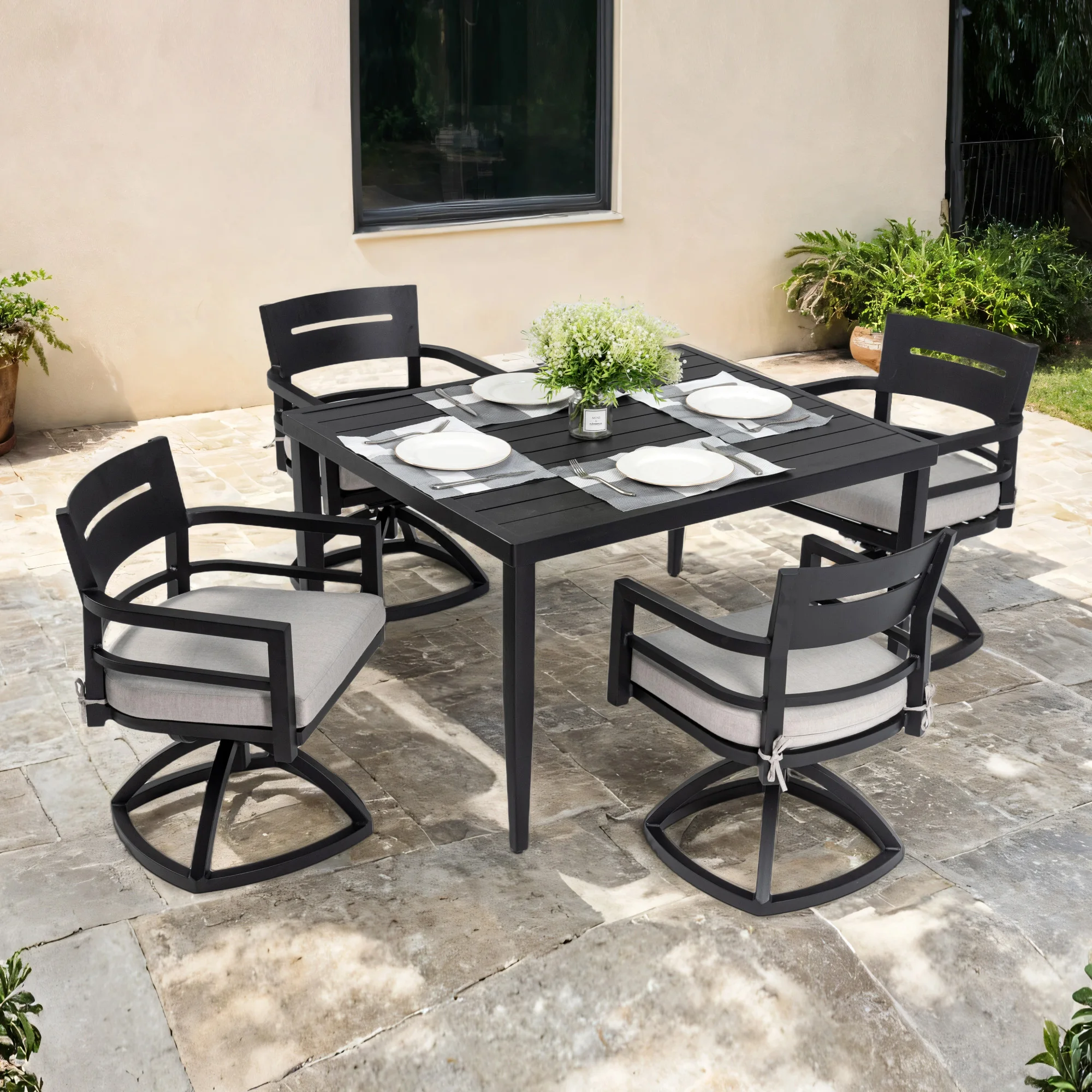 5-piece aluminum outdoor dining set with swivel rockers and glass table on a patio