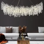 Modern crystal chandelier illuminating a dining room with tree branch design