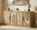 Modern rattan sideboard buffet with four doors and natural wood finish in a living room setting