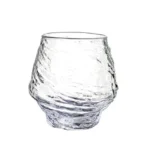Set of hazy wine glasses with hammer pattern and snowflake design on a wooden table