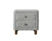 Cleo Gray boucle nightstand with drawers and wooden legs in a cozy bedroom setting
